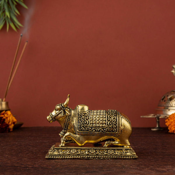 Sitting Brass Cow Idol with Yellow Accents & Curved Horns – Sacred Gau Mata Statue for Home Decor & Pooja